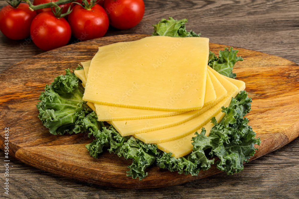 Sliced Gauda cheese over board Sliced Gauda cheese over board