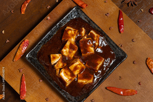 chinese tradition food,Mapo Tofu(Spicy hot tofu) with rice,ancient decorations and spices(pepper,chili and star anise). photo