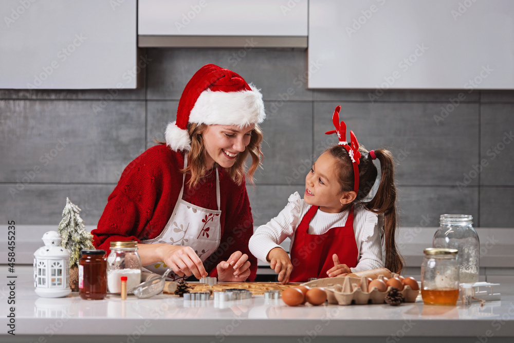 Mother and daughter making Christmas cookies in the kitchen Mother and daughter making Christmas cookies in the kitchen