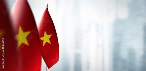 Small flags of Vietnam on a blurry background of the city
