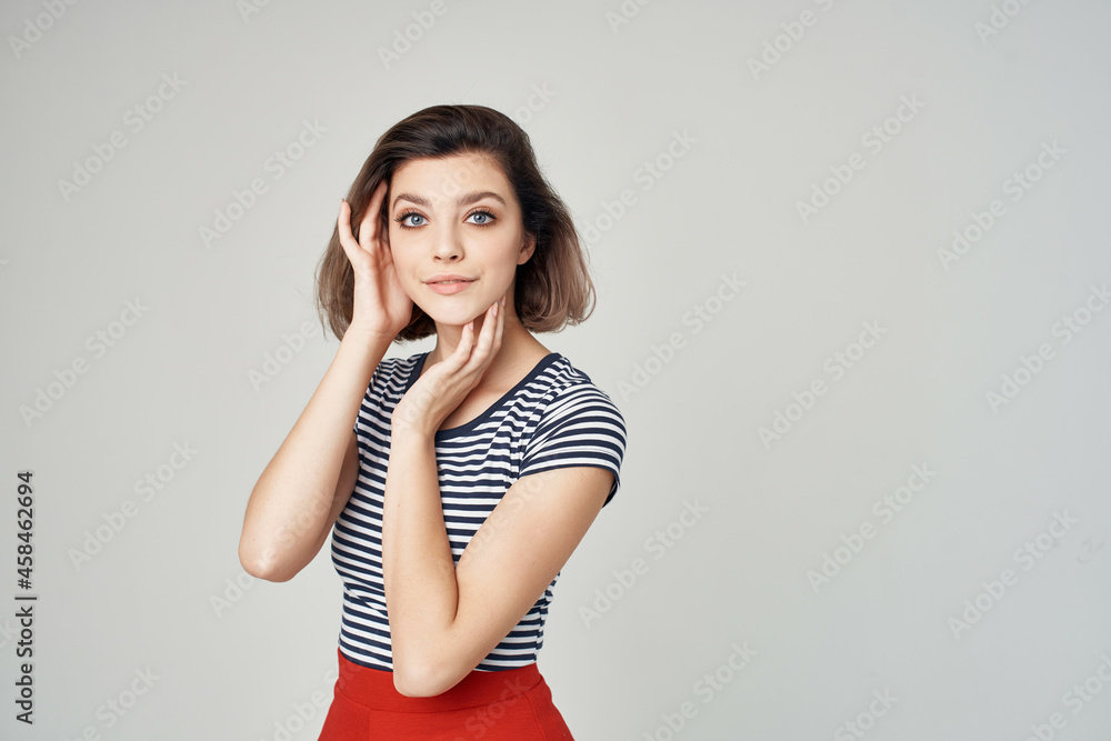 woman in a striped T-shirt Red skirt cropped view glamor woman in a striped T-shirt Red skirt cropped view glamor