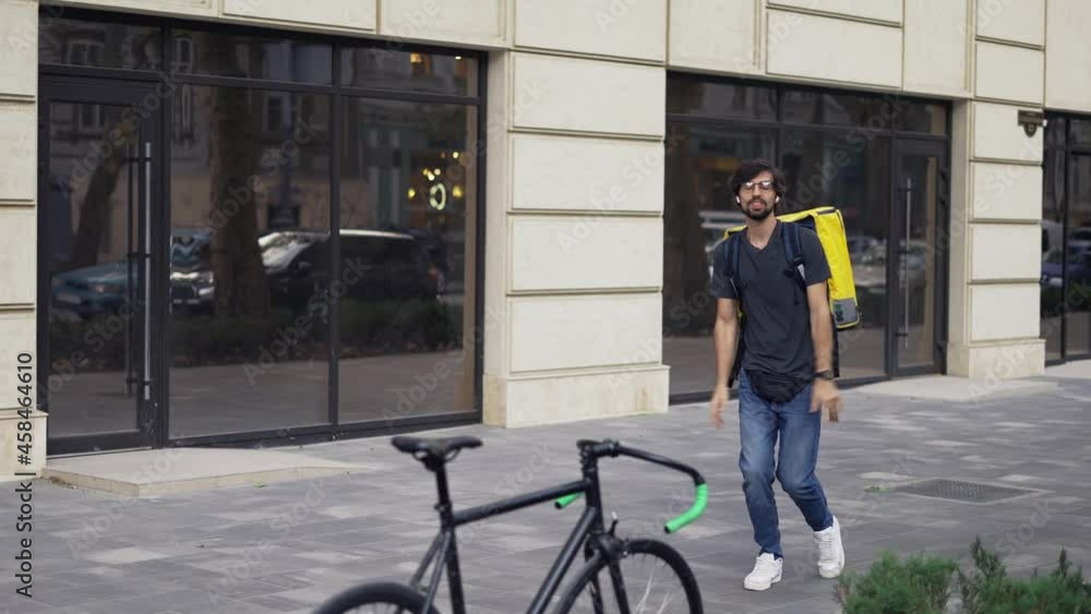 A bearded guy with a backpack is fooling around and dancing, slow motion A bearded guy with a backpack is fooling around and dancing, slow motion