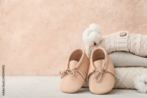 Stylish baby clothes on color background photo