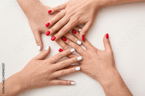 Many female hands with beautiful manicure on white background  closeup