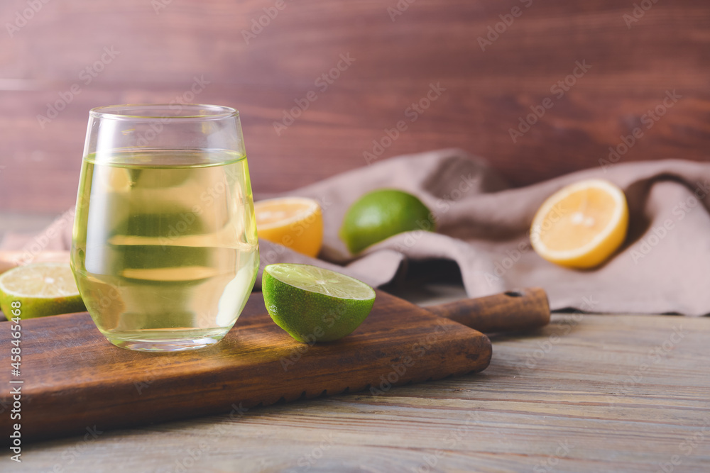 Glass of tasty drink with citrus fruits and ginger on wooden background Glass of tasty drink with citrus fruits and ginger on wooden background