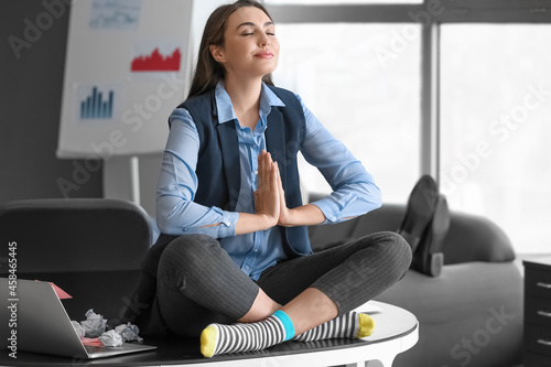 Lazy woman meditating in of...