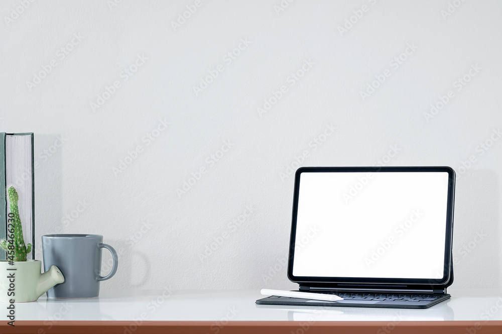 Creative workspace with blank screen tablet on white top table. Creative workspace with blank screen tablet on white top table.