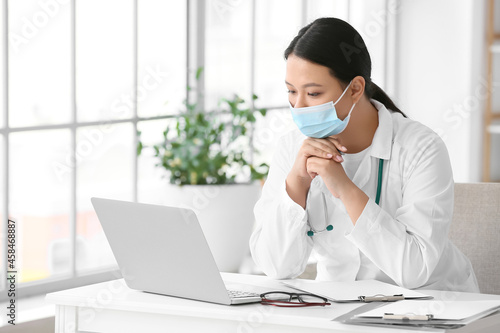 Female Asian doctor wearing...