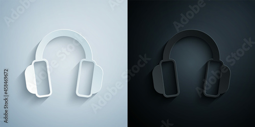 Paper cut Headphones icon isolated on grey and black background. Earphones. Concept for listening to music, service, communication and operator. Paper art style. Vector