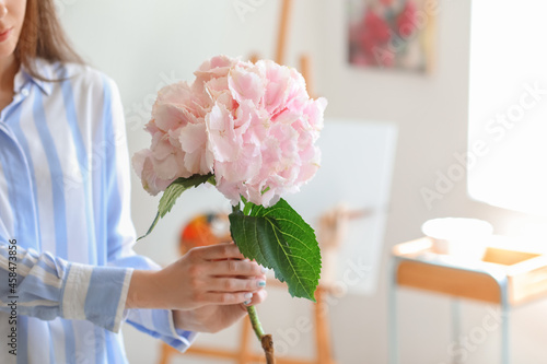 Young woman with hydrangea ...