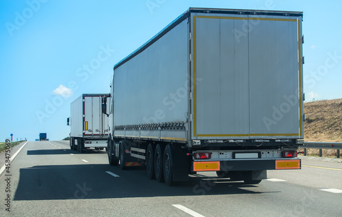 Trucks move along a suburban highway