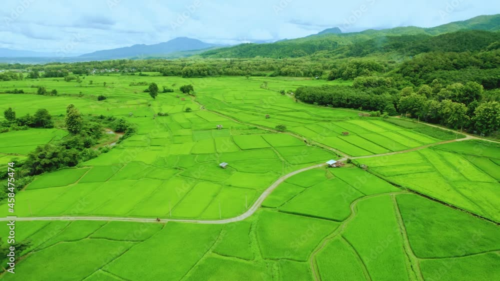 Beautiful aerial view of rice paddy field in Sapan village a small village nestled in a forested northern valley of pure air and pristine rivers in Nan province of Thailand. Beautiful aerial view of rice paddy field in Sapan village a small village nestled in a forested northern valley of pure air and pristine rivers in Nan province of Thailand.