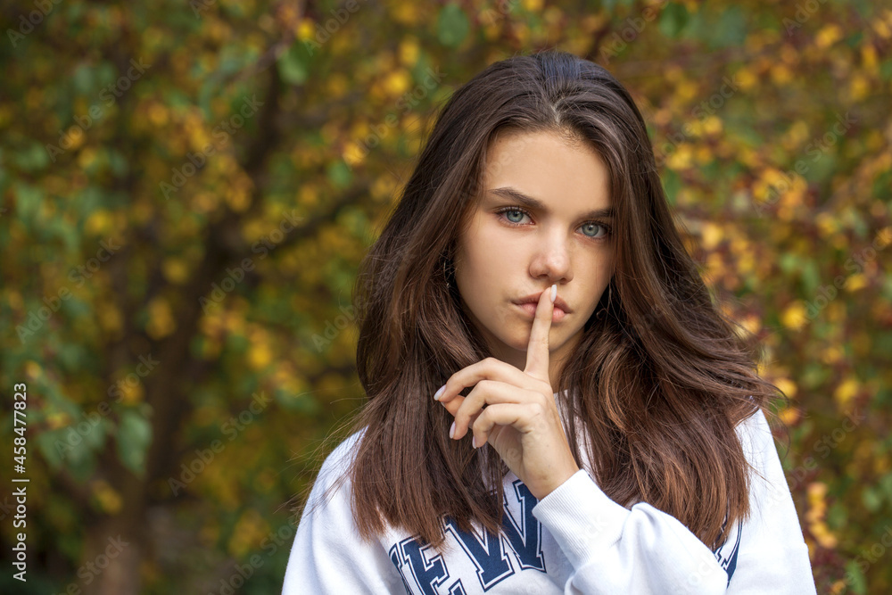 Young beautiful brunette girl, autumn park outdoors Young beautiful brunette girl, autumn park outdoors