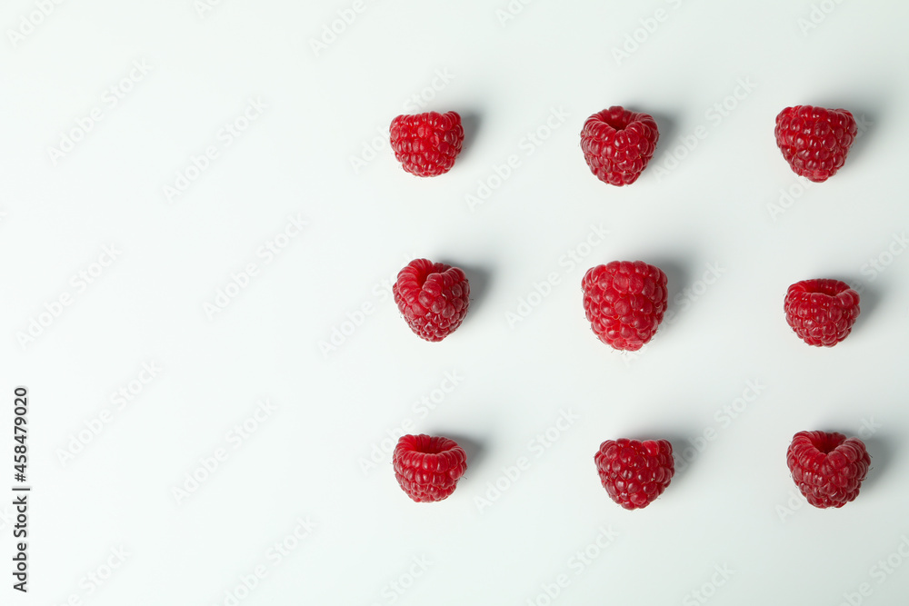 Flat lay composition with red juicy raspberries on a white background . Flat lay composition with red juicy raspberries on a white background .
