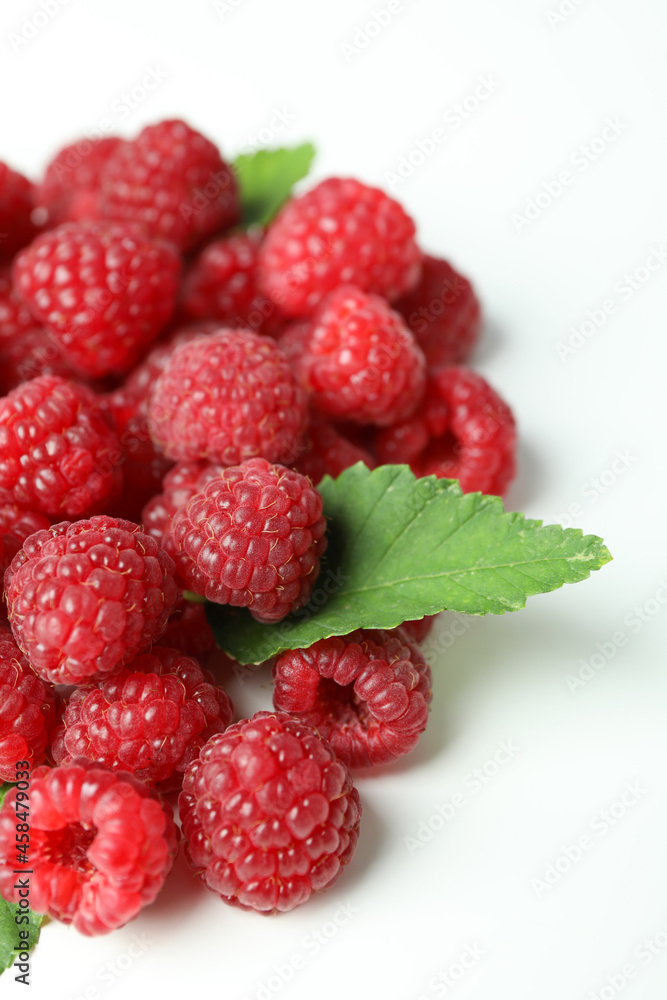 A handful of red juicy raspberries on a white background, close up A handful of red juicy raspberries on a white background, close up
