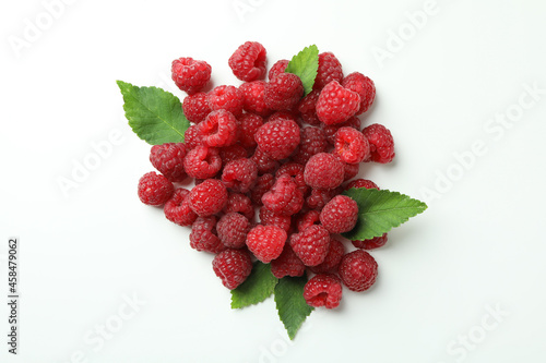 A handful of red juicy raspberries on a white background, close up