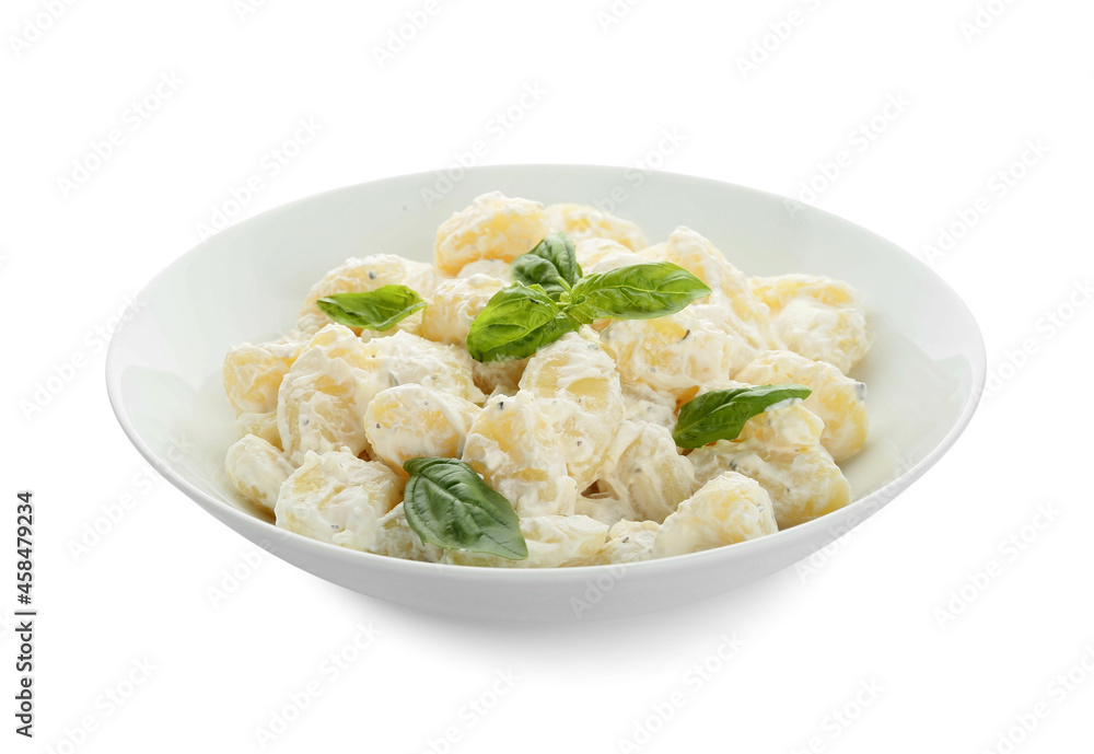 Bowl of delicious gnocchi with creamy sauce on white background Bowl of delicious gnocchi with creamy sauce on white background
