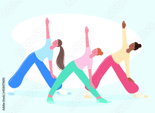 Group aerobics, fitness and yoga classes.  People stand in triangle pose trikonasana.  Healthy lifestyle  concept. 