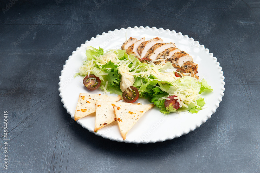 Fried chicken breast and salad in a plate Fried chicken breast and salad in a plate