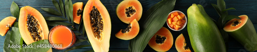 Fresh ripe papaya on wooden background, top view photo