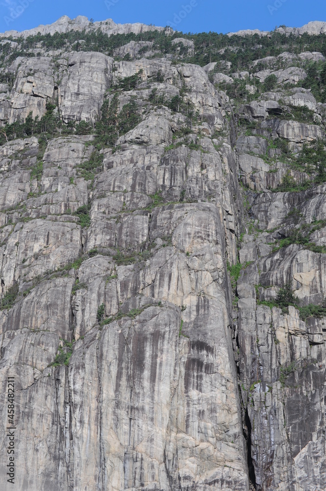 White and grey extremely steep granite rock walls of Lysefjord fjord and canyon in Norway in Scandinavia White and grey extremely steep granite rock walls of Lysefjord fjord and canyon in Norway in Scandinavia