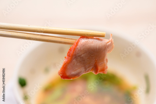 Pork chopsticks close up behind the bowl