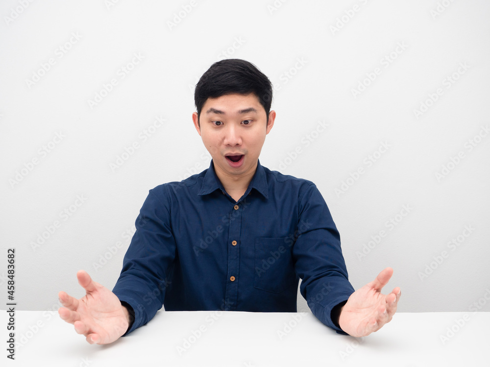 Man feeling excited looking on table copy space Man feeling excited looking on table copy space