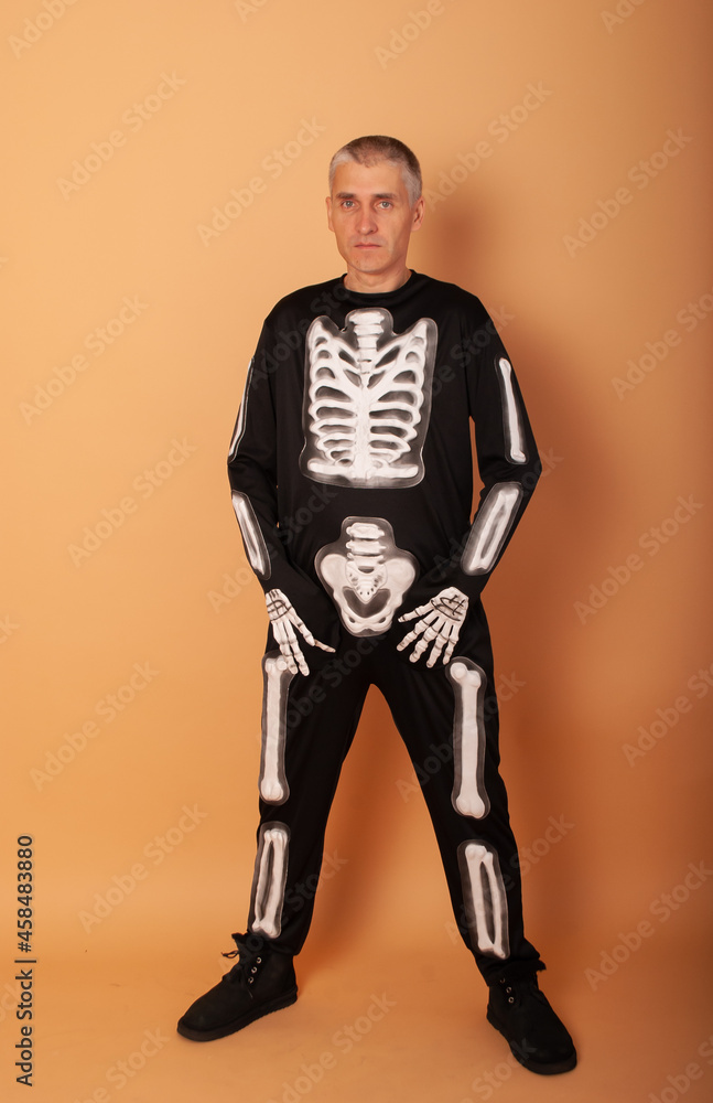 an elderly man in the form of a skeleton on a beige background isolated on Halloween