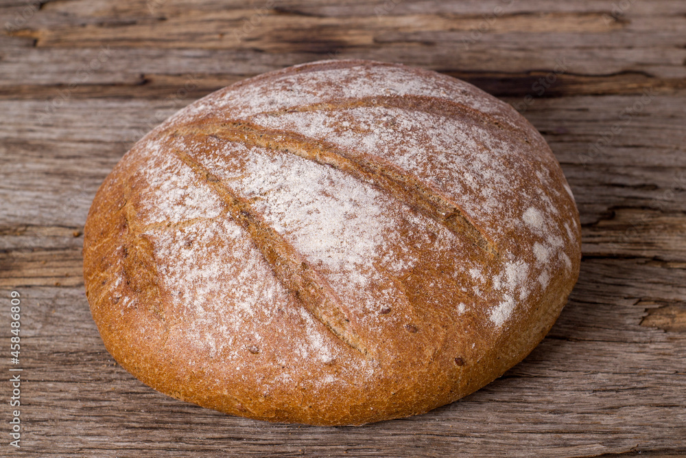 Loaf of buckwheat bread on wooden background
