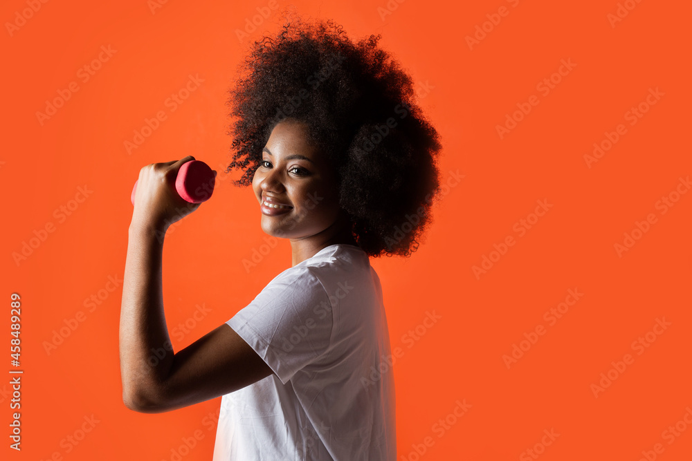 portrait of beautiful african woman with dumbbells portrait of beautiful african woman with dumbbells