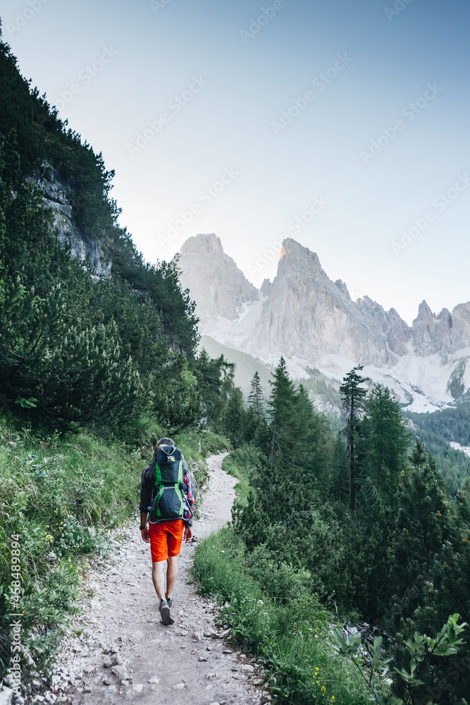 Young dad with baby boy travelling with backpack. Father on hiking adventure with child, family trip in mountains. Vacations journey with infant, Dolomites, Italy