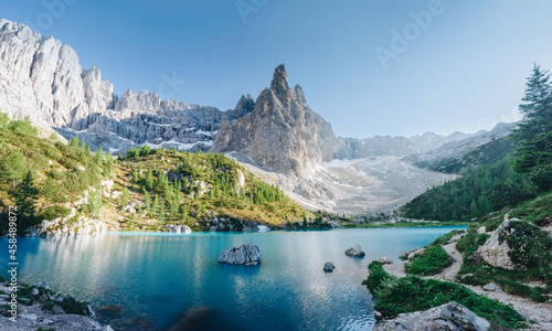 Wonderful hiking, photography and recreation place. Famous lake Sorapis with high snowy mountains at sunset, Dolomites, Italy, Europe photo