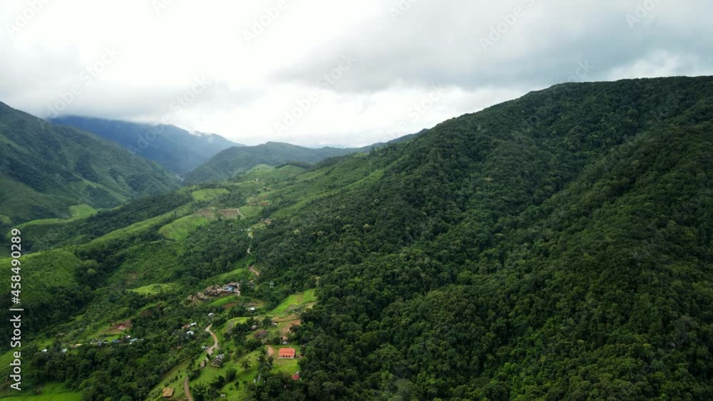 Aerial drone shot Flying forward, mountain peaks spectacular landscape Rainforest many trees fresh green at Sapan village, Nan Province, Northern Thailand. Aerial drone shot Flying forward, mountain peaks spectacular landscape Rainforest many trees fresh green at Sapan village, Nan Province, Northern Thailand.