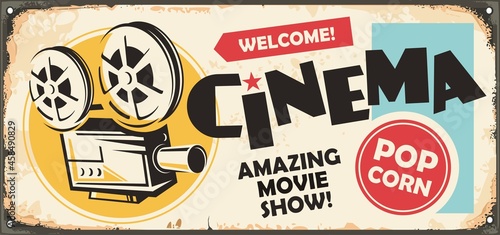 Retro cinema ad on old metal background. Retro sign with movie projector and creative typography. Vintage decorative poster with film camera graphic.