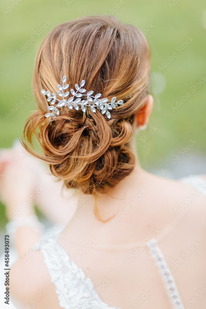 Beautiful bridal hairstyle with hair accessories. Classic hairstyle for the wedding 