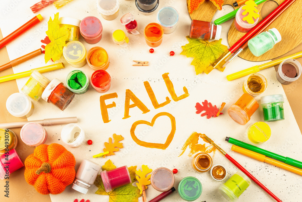 Creative autumn colors composition. Gouache, brushes, paper, traditional decor, and the word Creative autumn colors composition. Gouache, brushes, paper, traditional decor, and the word