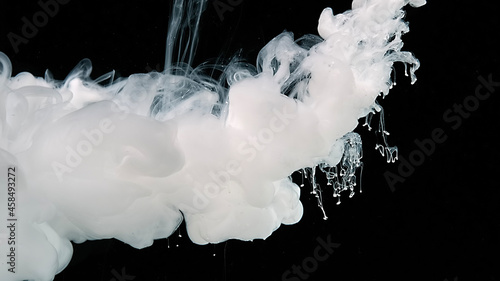 White abstract background. White watercolor ink in water on a black background.