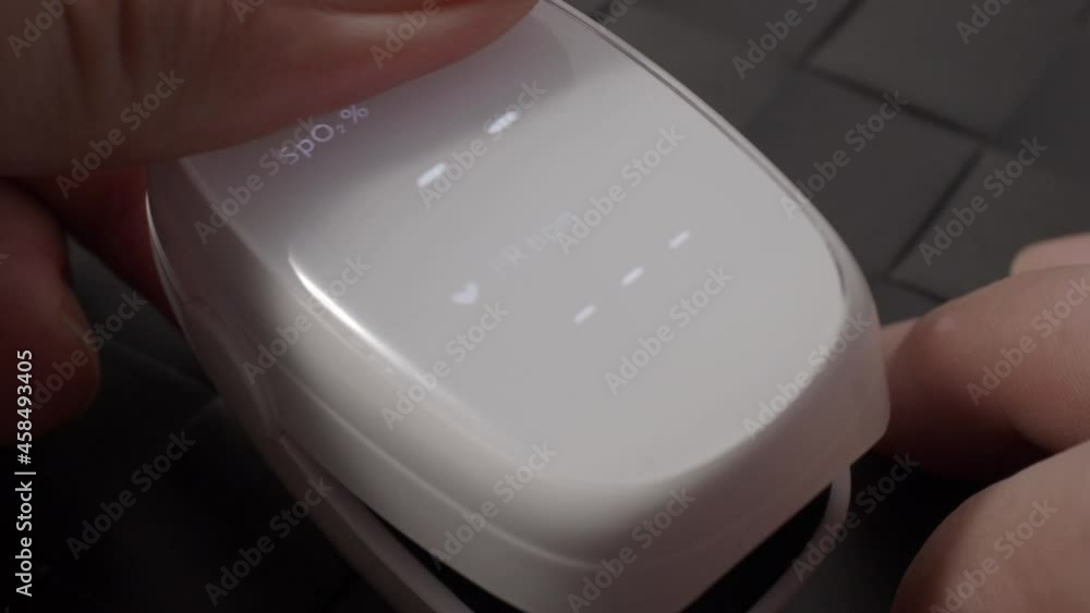 Oximeter usage. Finger pulse oximeter used to measure pulse rate and oxygen levels. Home self care during Covid 19 pandemic. healthcare monitoring concept. using portable fingertip pulse oximeter. 4k Oximeter usage. Finger pulse oximeter used to measure pulse rate and oxygen levels. Home self care during Covid 19 pandemic. healthcare monitoring concept. using portable fingertip pulse oximeter. 4k