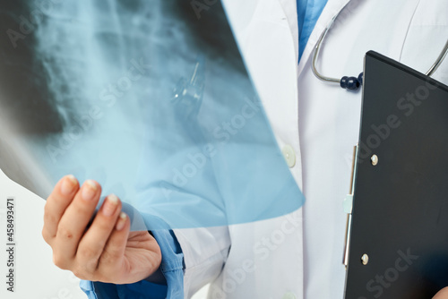 doctor in white coat with x-ray health care light background