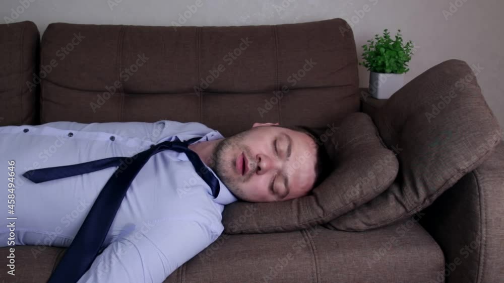 Drunk man falling on sofa. Male alcoholic falling on couch after drinking too much beer in weekend at home. ALCOHOLISM concept Drunk man falling on sofa. Male alcoholic falling on couch after drinking too much beer in weekend at home. ALCOHOLISM concept