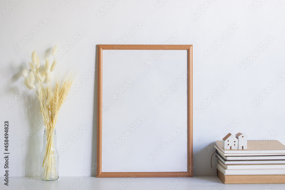 A brown blank frame with flowers over the white background. A brown blank frame with flowers over the white background.