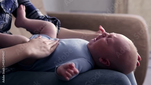 Close up mother Hands Holding Baby leg and Exercise for Healthy smiling and  happiness emotional in cozy bedroom,Exercise Healthy Baby Concept