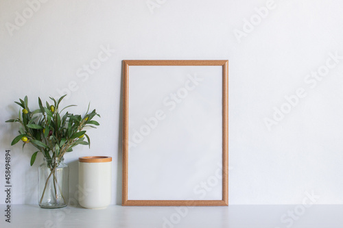 A brown blank frame with flowers over the white background. 