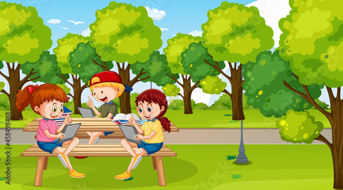 Kids leaning online with tablet in the park