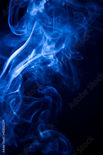 Motion blue smoke on black background.