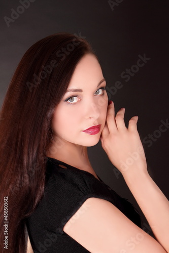 Young brunette woman with long hair  portrait of female model 