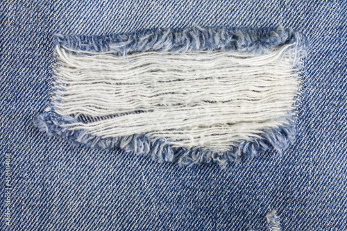 Blue torn denim jeans texture.