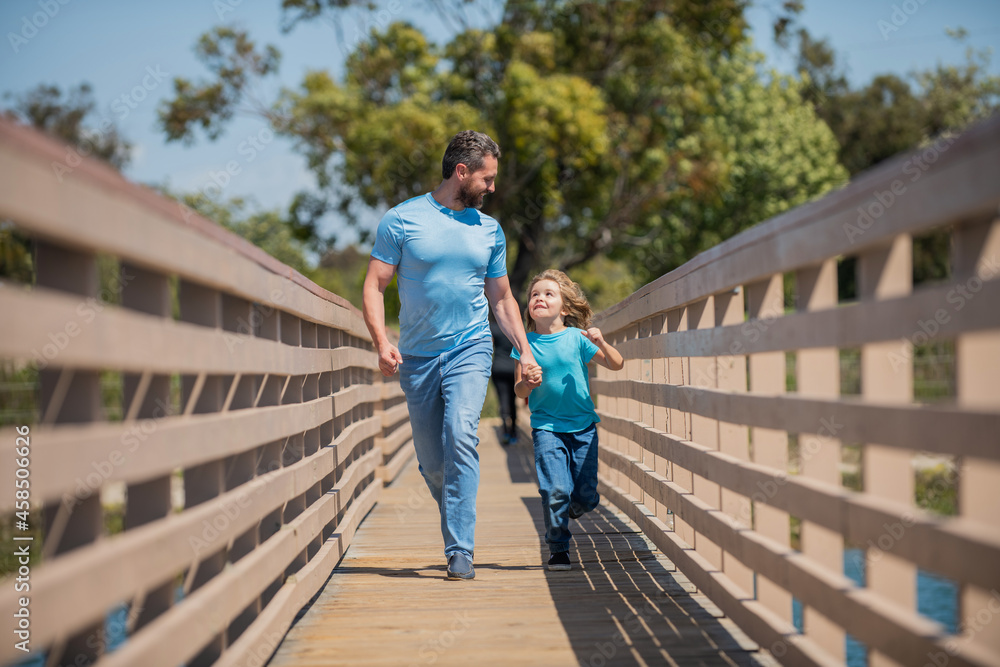 happy daddy having fun running with his son outdoor, adoption happy daddy having fun running with his son outdoor, adoption