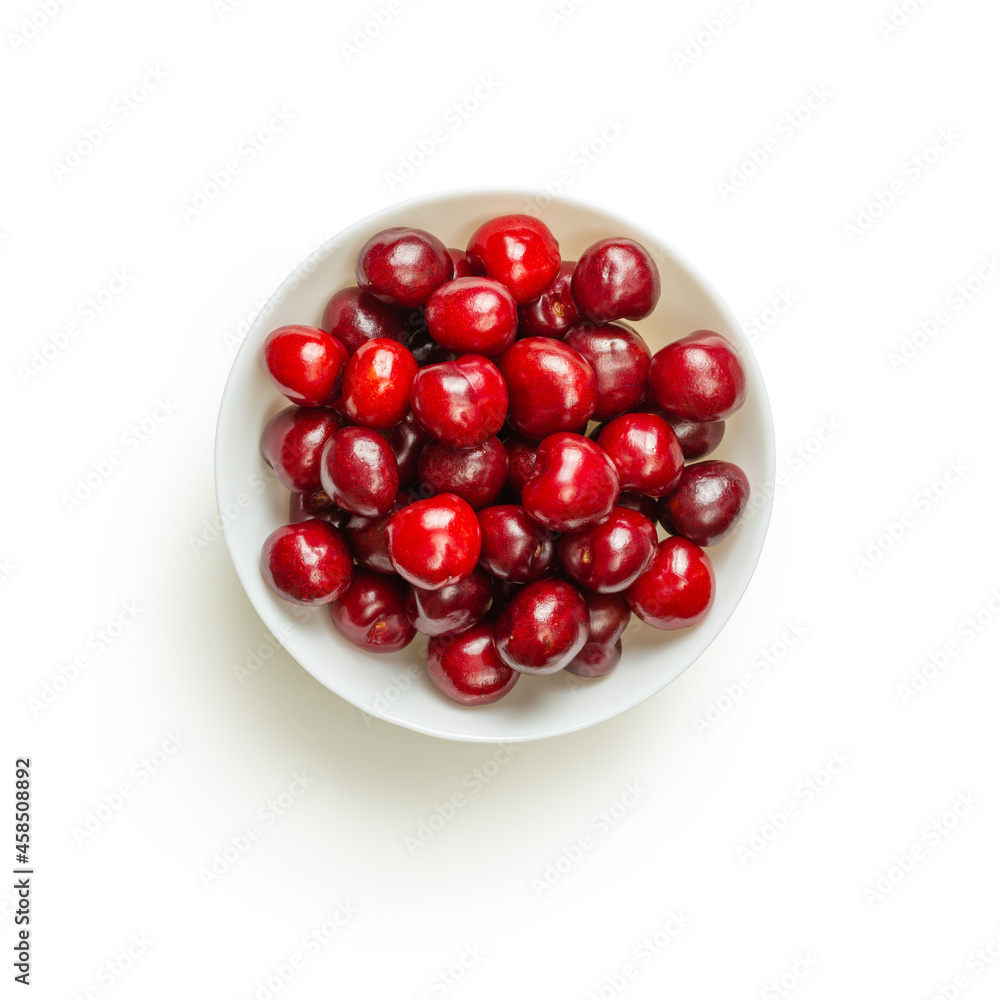 Isolated red sweet cherries in a white bowl on a white background Isolated red sweet cherries in a white bowl on a white background