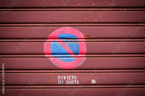 Parking prohibited steet signs on old roller shutter in italy street photo